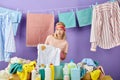 Sad unhappy fair-haired woman holding dirty T-shirt Royalty Free Stock Photo