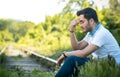 Sad or unhappy man sitting on a train lines Royalty Free Stock Photo