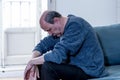 Sad unhappy old senior man suffering from memory loss and alzheimer feeling depressed and lonely Royalty Free Stock Photo