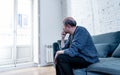 Sad unhappy old senior man suffering from memory loss and alzheimer feeling depressed and lonely Royalty Free Stock Photo