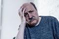 Sad unhappy old senior man suffering from memory loss and alzheimer feeling depressed and lonely Royalty Free Stock Photo