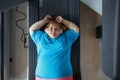 Sad unhappy overweight woman feeling pain while training at wall for posture correction Royalty Free Stock Photo