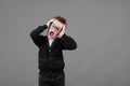 Sad unhappy schoolboy in eyewear having painful look, holding hand on his forehead. Frustrated sick child with a shout suffering Royalty Free Stock Photo