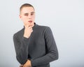 Sad unhappy young man thinking with hand under the face and looking down Royalty Free Stock Photo