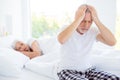 Sad unhealthy gray hair man in checkered pants nightwear sits on Royalty Free Stock Photo