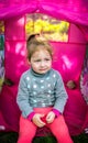 Sad, upset child sitting in a tent in the garden Royalty Free Stock Photo