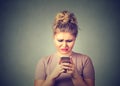 Sad upset woman using mobile phone Royalty Free Stock Photo