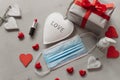 Sad valentine`s day during covid pandemic concept. black and white hearts with medical face mask and lipstick. celebrating love Royalty Free Stock Photo