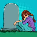 A sad widow or daughter near a grave in the cemetery. Memorial day, veteran father or husband. Royalty Free Stock Photo