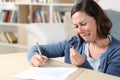 Sad wife crying signing divorce papers at home Royalty Free Stock Photo