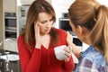 Sad Woman Being Consoled At Home By Female Friend Royalty Free Stock Photo