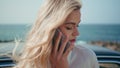 Sad woman calling phone standing at ocean shore closeup. Girl talking smartphone Royalty Free Stock Photo