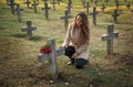 Sad woman in the cemetery .