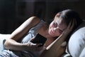 Sad woman complaining with phone at night at home Royalty Free Stock Photo