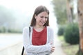 Sad woman crying alone walking in a foggy park