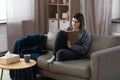 sad woman with diary sitting on sofa at home Royalty Free Stock Photo