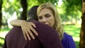 Sad woman embraces black boyfriend, worried because of family disapproval Royalty Free Stock Photo