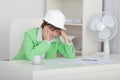 Sad woman engineer sits at table on workplac Royalty Free Stock Photo