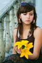 Sad young fashion woman with a flowers Royalty Free Stock Photo