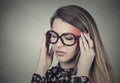 Sad woman in glasses with stressed face expression headache pain touching temples Royalty Free Stock Photo