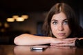 The sad woman has laid her head on the table and is waiting for a phone call Royalty Free Stock Photo