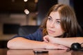 The sad woman has laid her head on the table and is waiting for a phone call Royalty Free Stock Photo