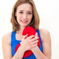 Sad woman holding red valentine heart Royalty Free Stock Photo