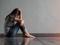 Sad woman hug her knee and cry while sitting alone Royalty Free Stock Photo