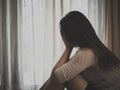 Sad woman hug her knee and cry while sitting alone Royalty Free Stock Photo