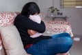 Sad Woman Hugging Pillow on Sofa