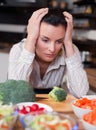 Sad woman in kitchen