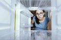 Sad woman looking into her empty fridge Royalty Free Stock Photo