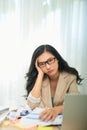 Sad Woman Looking At Laptop Touching Head Having Problems At Work Sitting In Modern Office Royalty Free Stock Photo