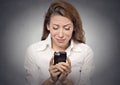 Sad woman looking at mobile phone Royalty Free Stock Photo