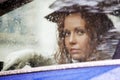 Sad woman looking out the car window Royalty Free Stock Photo