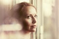 Sad woman looking out window Royalty Free Stock Photo