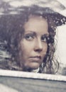 Sad woman looking out window driving a car Royalty Free Stock Photo