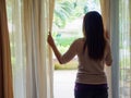 Sad Woman looking out a window, indoors. Royalty Free Stock Photo