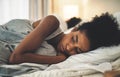 Sad woman lying on a bed in an unhappy marriage having problems. Upset female or couple in the bedroom after having an Royalty Free Stock Photo