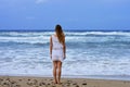 The sad woman observes the waves of the sea one of the last days of summer Before autumn Royalty Free Stock Photo