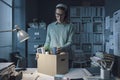 Sad woman packing her belongings in the office Royalty Free Stock Photo