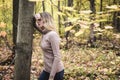 A Sad woman in park during autumn weather hiding face in hand, feeling terrible depressed.