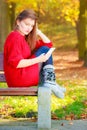 Sad woman in park with phone. Royalty Free Stock Photo