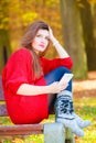 Sad woman in park with phone. Royalty Free Stock Photo