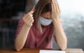 Sad woman in protective mask holding wedding ring in her hand Royalty Free Stock Photo