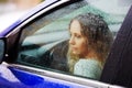 Sad woman in a car in the rain Royalty Free Stock Photo