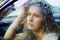 Sad woman looking through car window Royalty Free Stock Photo