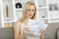 sad woman reading letter at home Royalty Free Stock Photo