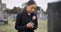 Sad woman, rose and graveyard in loss, grief or mourning at funeral, tombstone or cemetery. Female person with flower in