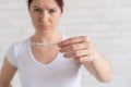 Sad woman shows a negative ovulation test. The concept of female infertility and low luteinizing hormone. Frustrated